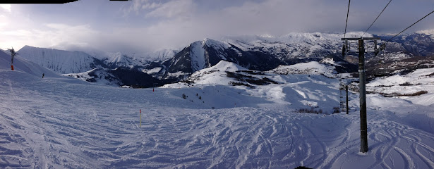 Image of a charming chalet at the Albiez-Montrond ski resort in Savoie Mont Blanc, France. The winter sports scene includes a bustling centre and a snow-covered mountain vista.