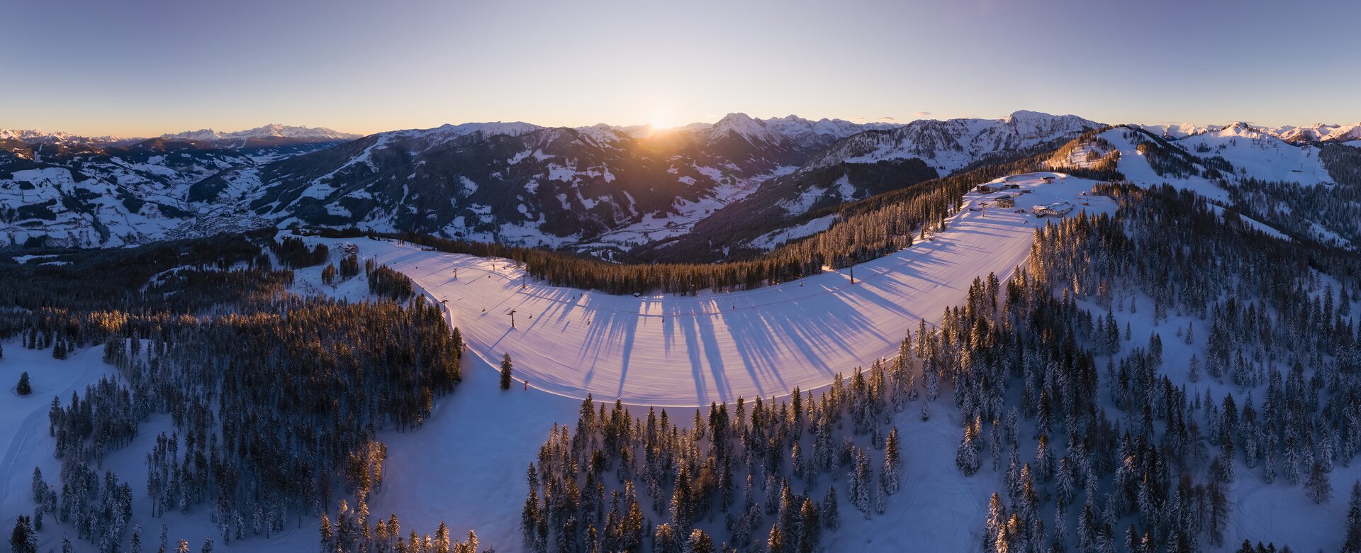 Snow Space Salzburg in Austria - the sun shines over the snow covered mountains in the canadian rockies.