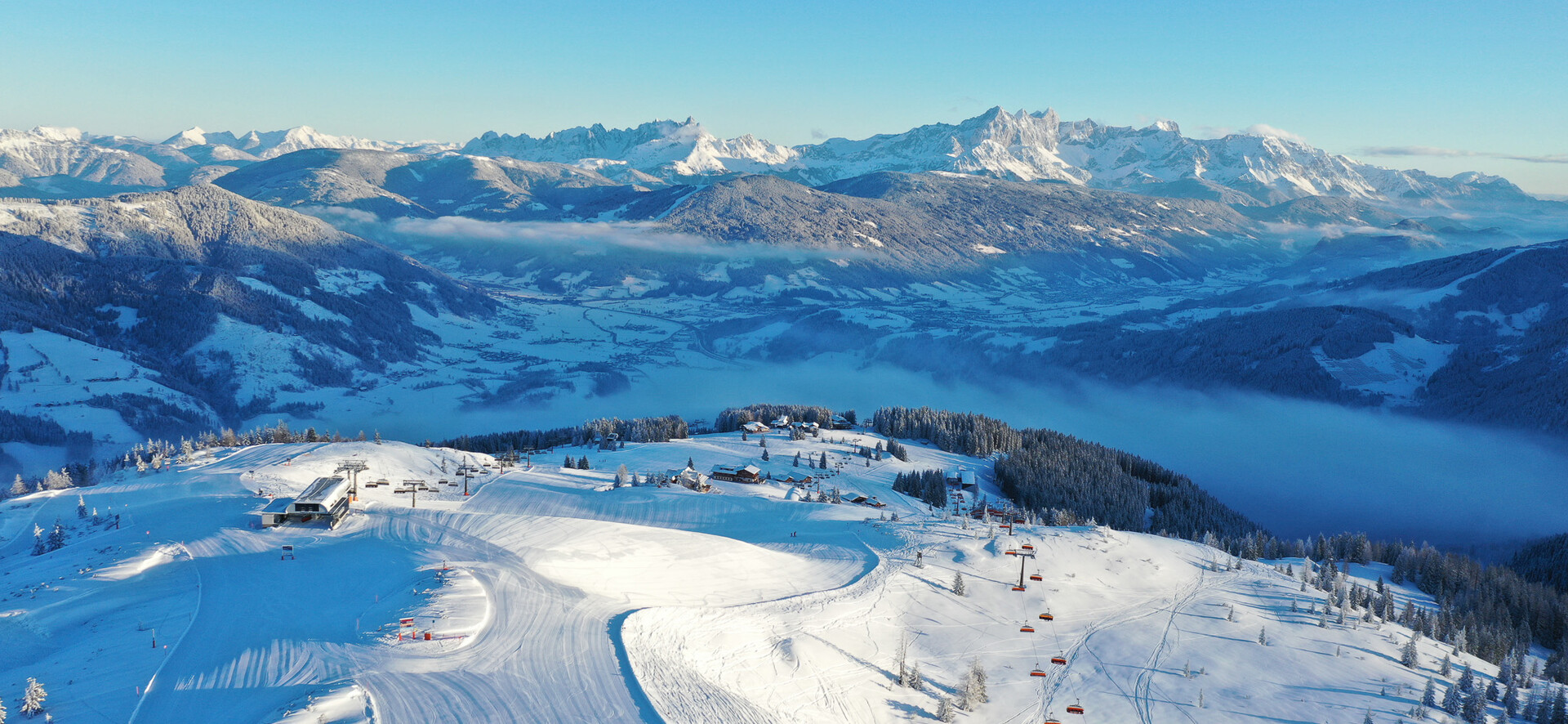 Snow Space Salzburg in Austria - a group of people skiing down a snow covered mountain.