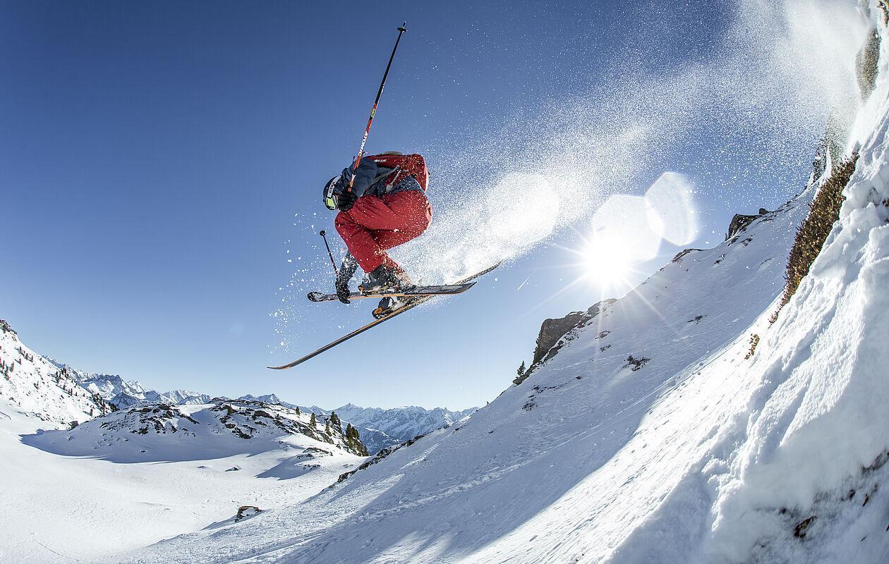 Hochzillertal | Hochfügen in Austria - a man flying through the air while riding skis.