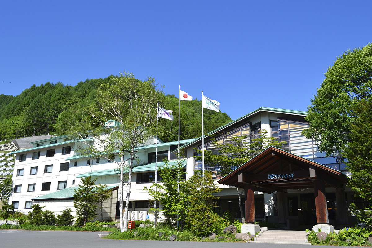 Oze Iwakura in Japan: a white building with a green roof.