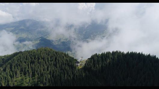 Scenic view of Olimpica-Borșa in Romania featuring a mountain backdrop, a ski resort, and accommodations like a chalet, mountain hut, and a lodge.