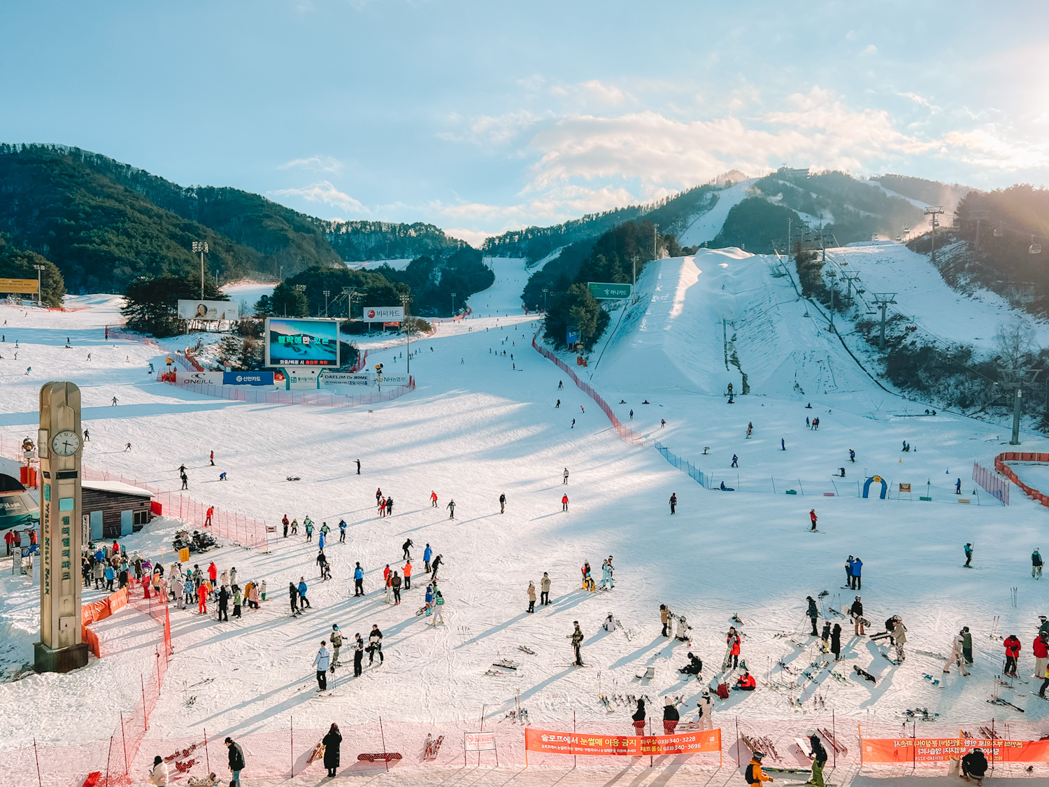 O2 Resort in South Korea - a group of people skiing down a snowy slope.