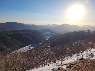 Stunning winter view at the O2 Resort in South Korea, highlighting the pristine snow-covered landscape and mountains amidst winter sports activities.