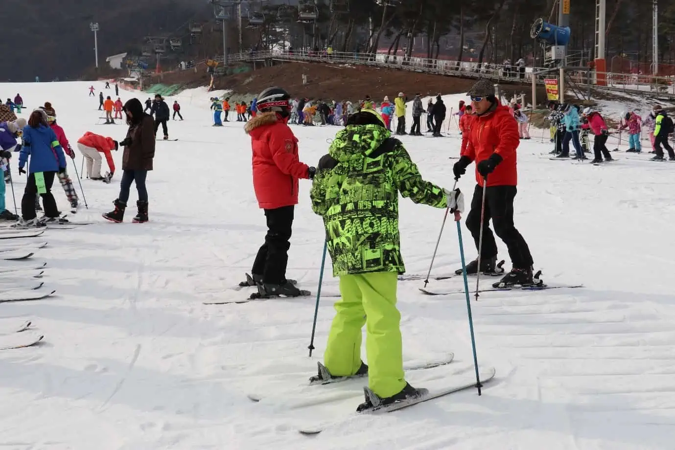 O2 Resort in South Korea - a group of people skiing down a snowy slope.