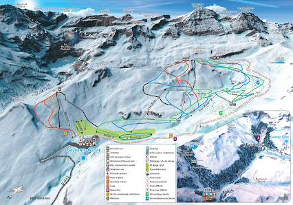View of Gavarnie-Gèdre ski resort in Occitanie, France below a clear sky. A chalet and ski lift stand under snowy mountains with a skier sliding down a trail, creating an active winter scene.