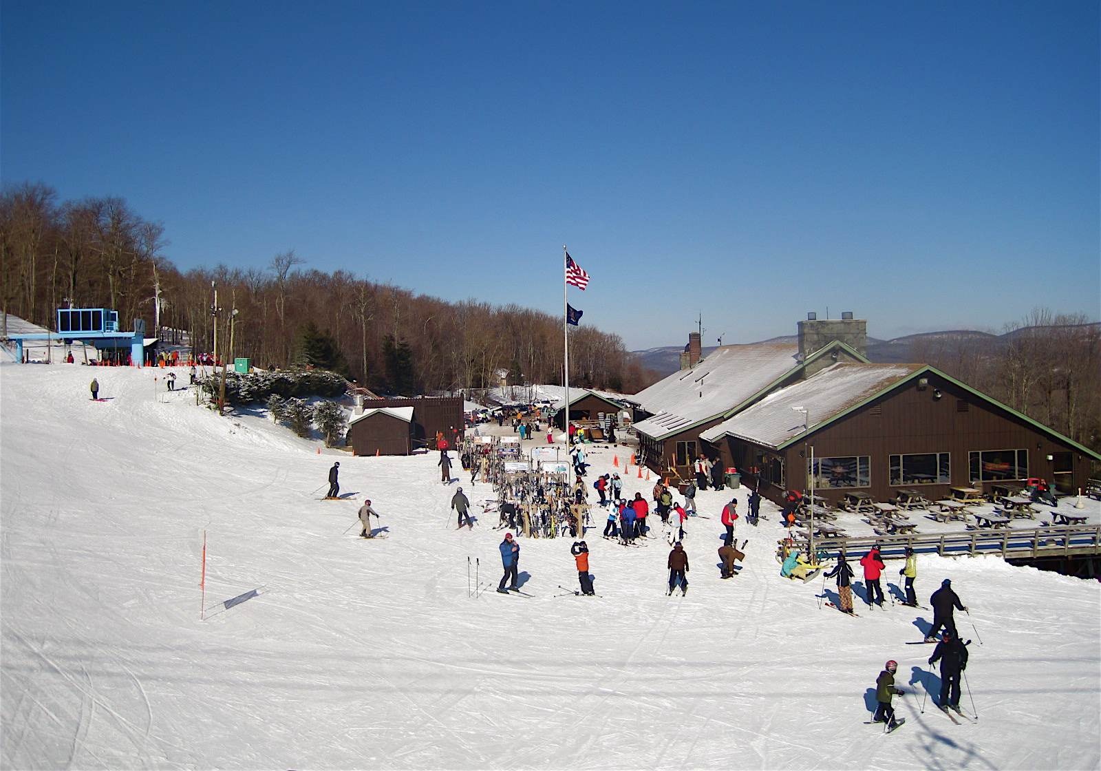 Belleayre Mountain in USA - a group of people skiing down a snowy hill.