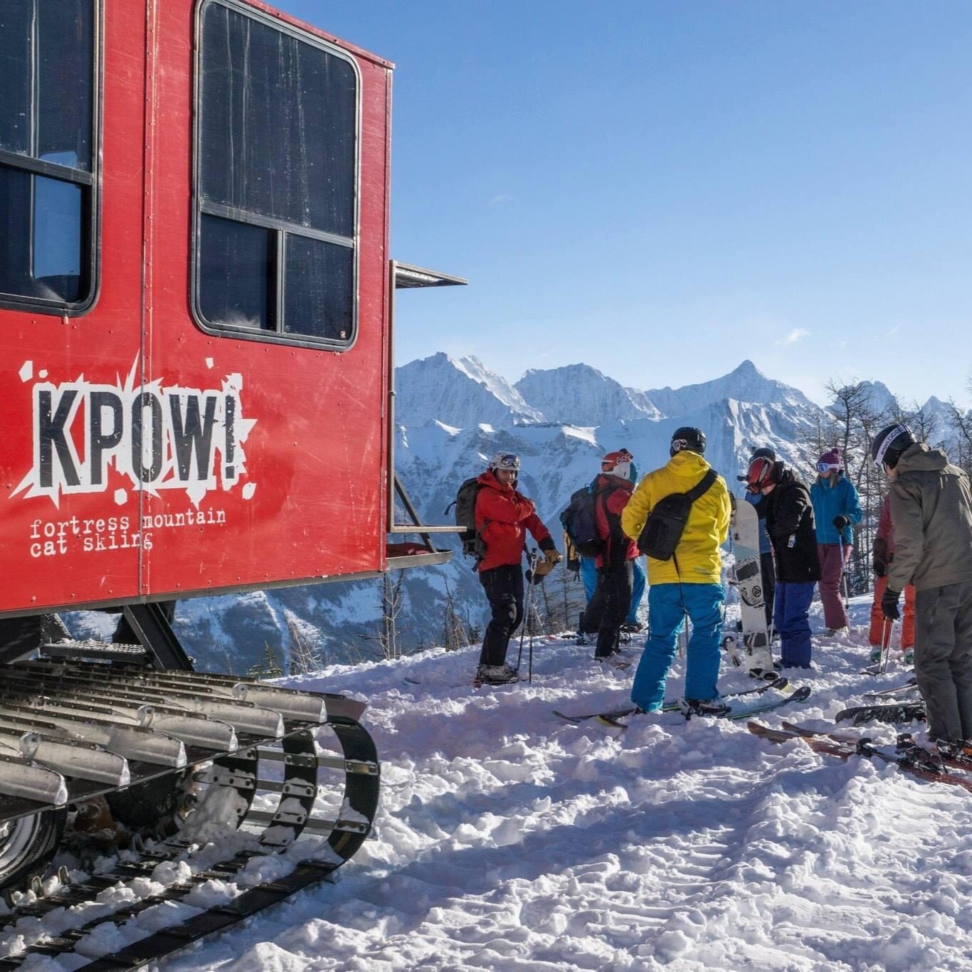 Fortress Mountain ski area in Canada - a group of people standing next to a red train.