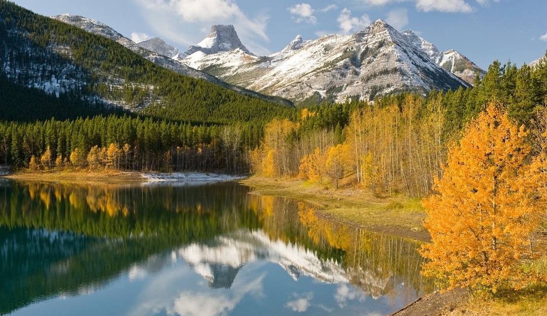 Fortress Mountain ski area in Canada - a lake surrounded by trees in the mountains.