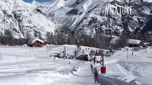Winter sports enthusiasts enjoying the day at the ski resort in Pelvoux Vallouise, Hautes-Alpes, France, amidst a breathtaking winter scenery.