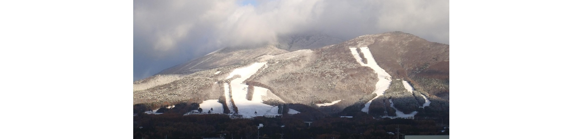 Inawashiro in Japan - a mountain covered in snow and clouds.