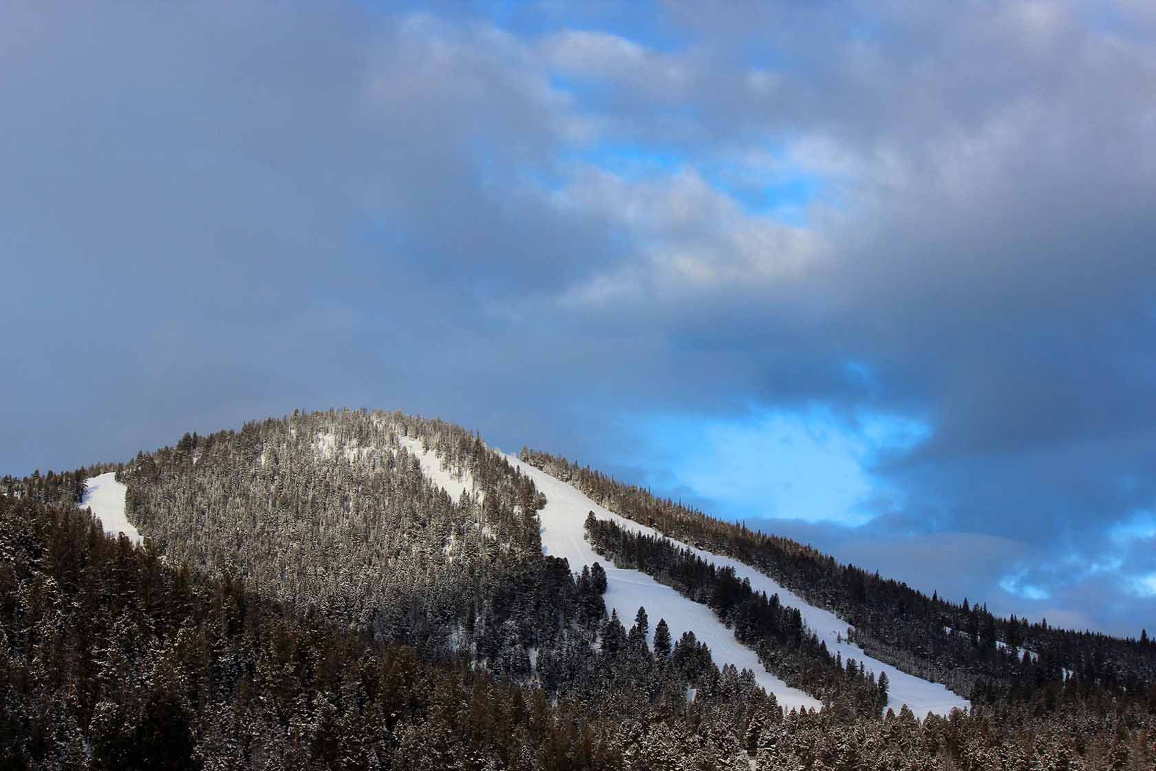 Maverick Mountain in USA - a mountain covered in snow under a cloudy sky.