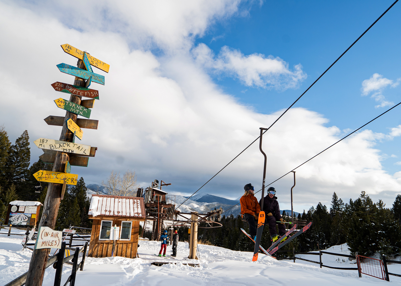 Maverick Mountain in USA - a man riding a snowboard down a snow covered slope.