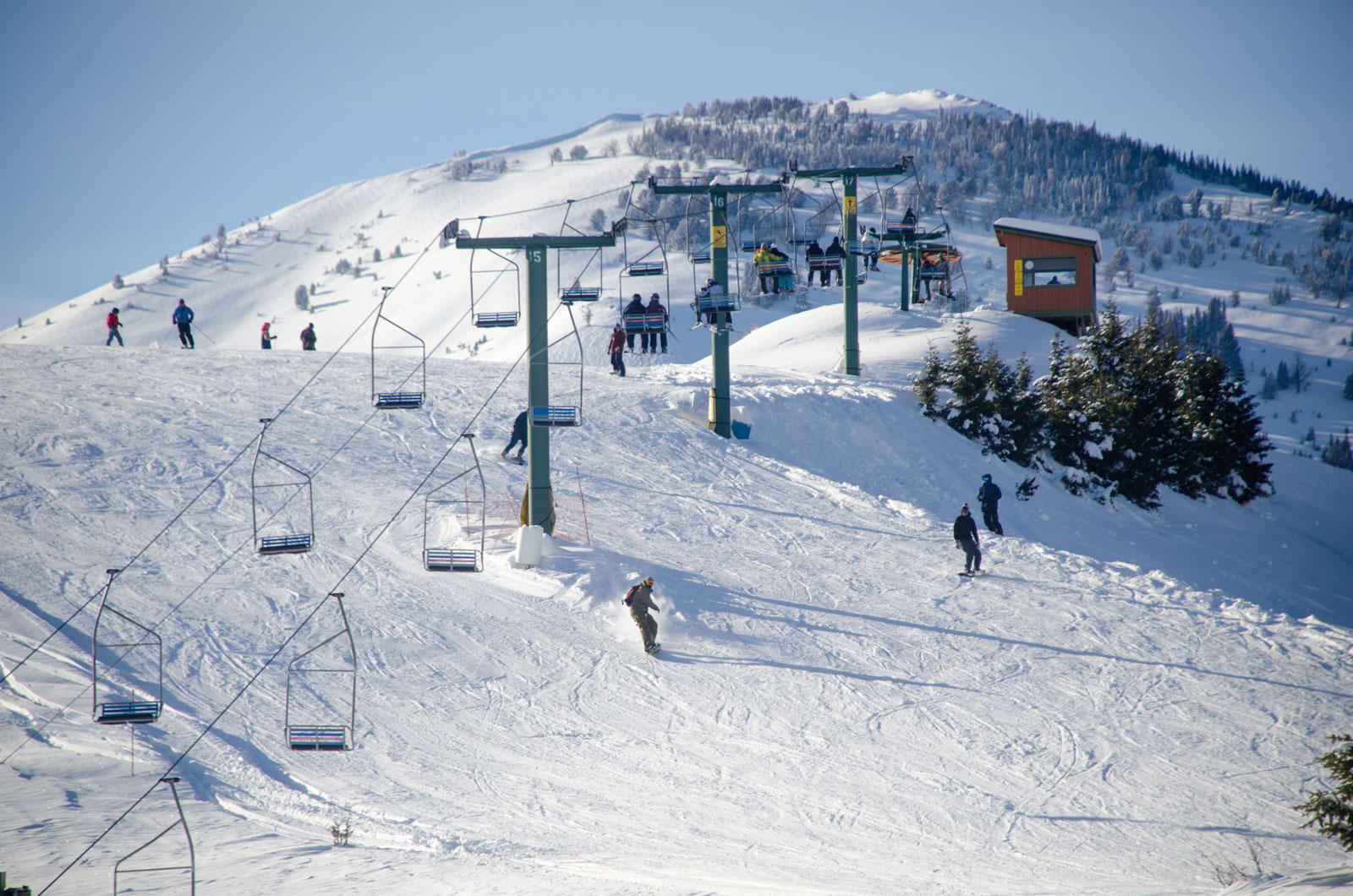 Soldier Mountain in USA - a group of people skiing down a snowy hill.