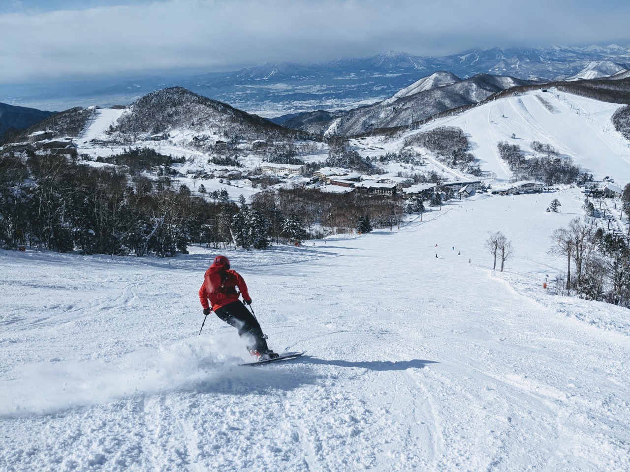Okushiga Kogen in Japan - a person skiing down a snow covered mountain.