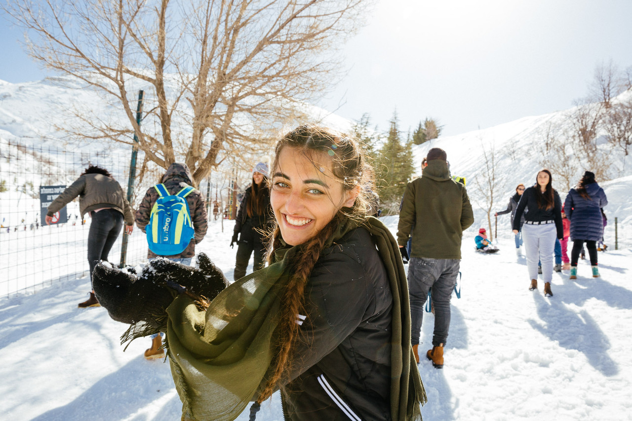 Mount Hermon – Neve Ativ in Israel - a woman holding a snowboard in the snow.