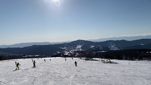 Sugadaira Kogen Taro ski resort in Nagano, Japan bustling with skiers enjoying the winter sports scene amidst a stunning snowy landscape.