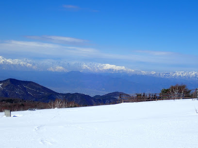 Ski enthusiasts enjoying winter sports at Sugadaira Kogen Taro, Chūbu, Nagano, Japan. The picturesque ski resort is dotted with charming chalets, surrounded by breathtaking winter scenery.