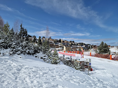 Winter scene at Cambre d'Aze – Eyne | ​Saint-Pierre-dels-Forcats in France, showcasing a bustling winter sports centre and ski resort, with a picturesque challet nestled amidst the snow-covered scenery.