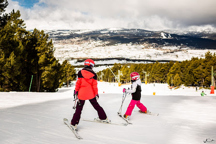 A lively winter sports scene at Cambre d'Aze – Eyne in France featuring multiple people skiing at a ski resort filled with fun and laughter perfectly encapsulating family holiday fun.