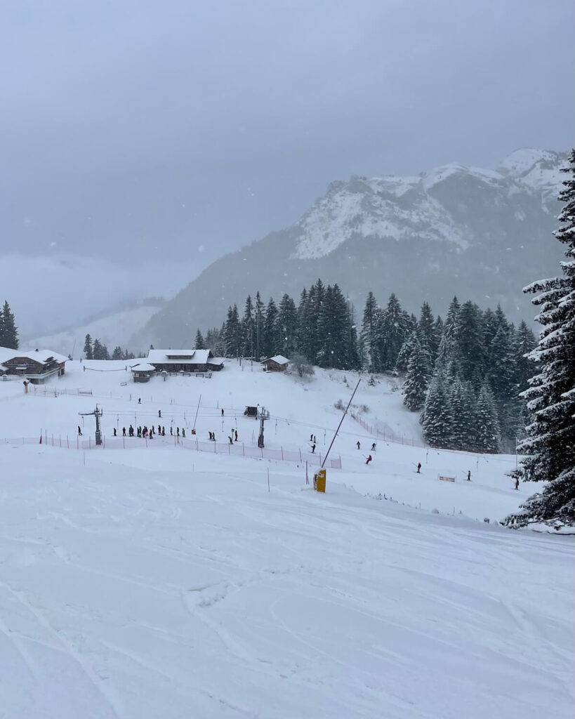 Bernex in France - a group of people skiing down a snow covered slope.