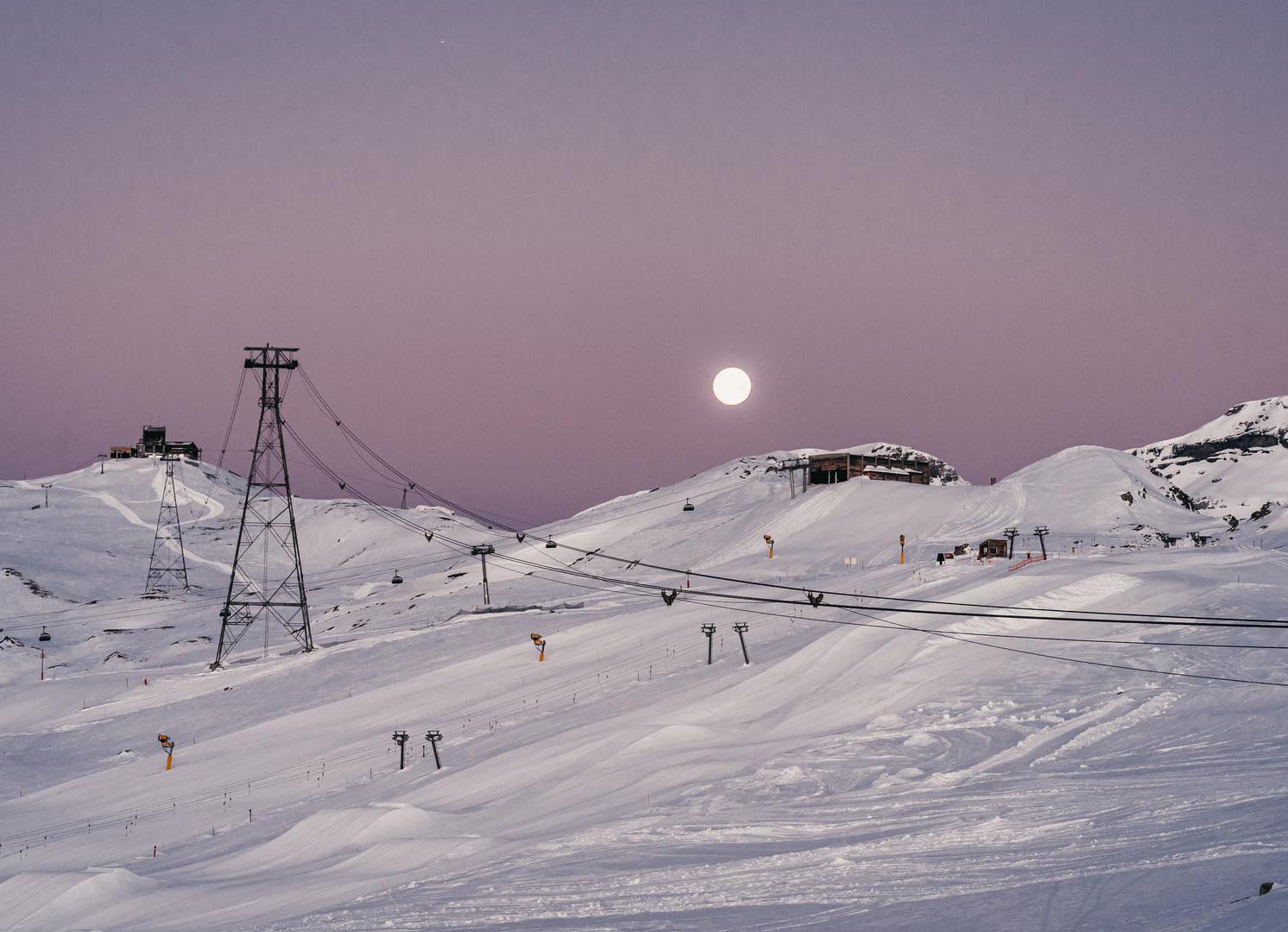 Flims Laax Falera in Switzerland - a group of people skiing down a snow covered mountain.