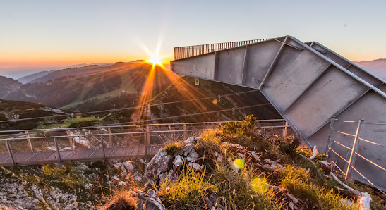 Scenic winter view of Hochkar Bergbahnen in Mostviertel Austria featuring a mountain a challet and a bustling winter sports centre hinting at nearby mountain biking and winter sports activities.