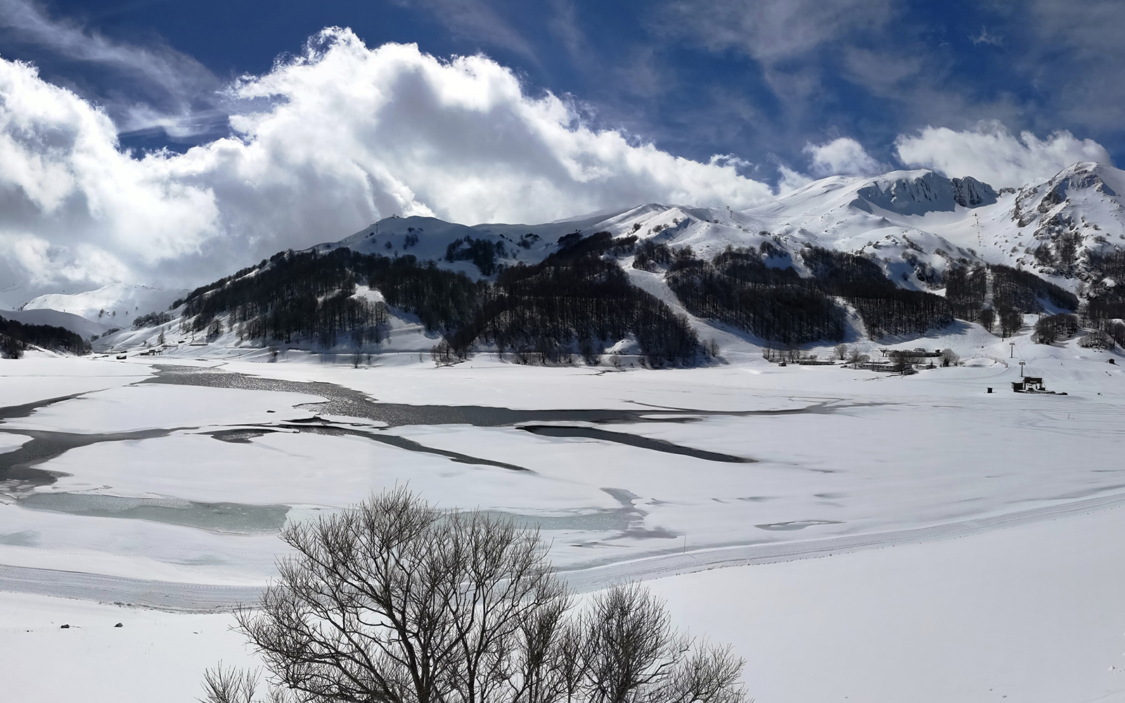 Campitello Matese in Italy - a view of a snowy landscape with mountains in the background.