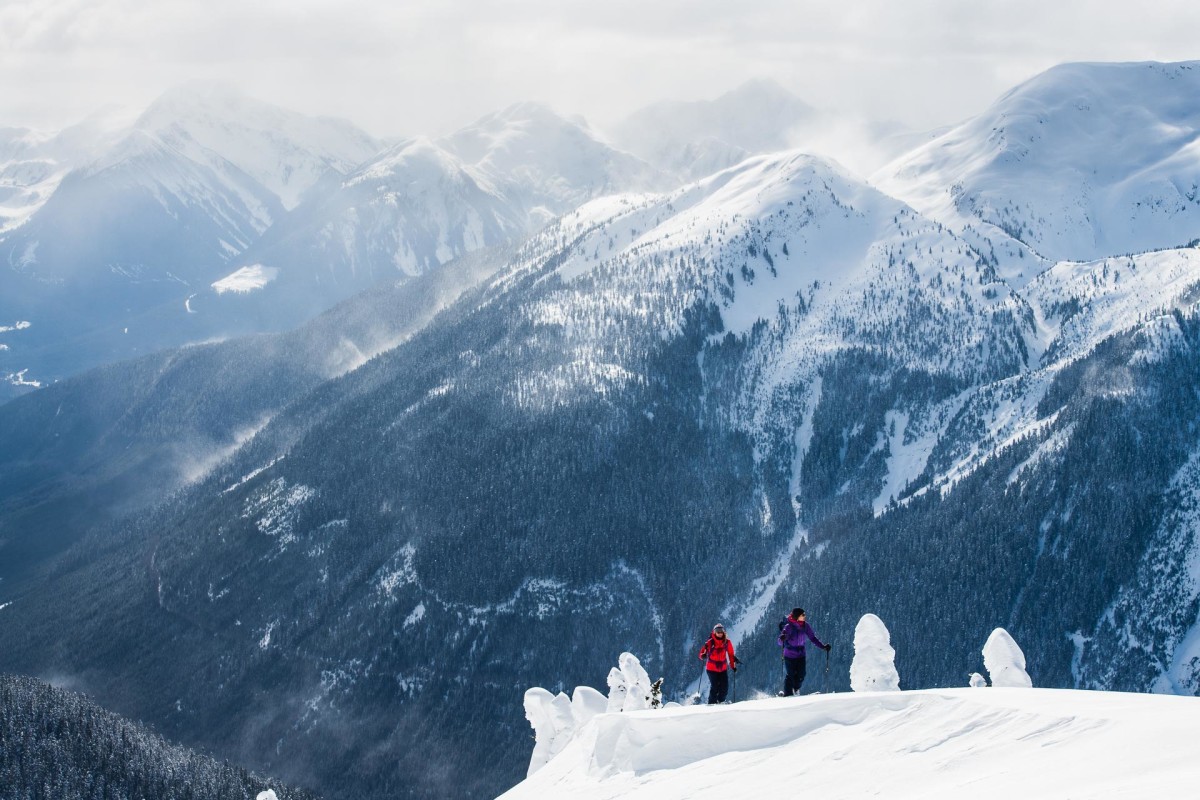 Shames Mountain in Canada - two people standing on top of a snowy mountain.