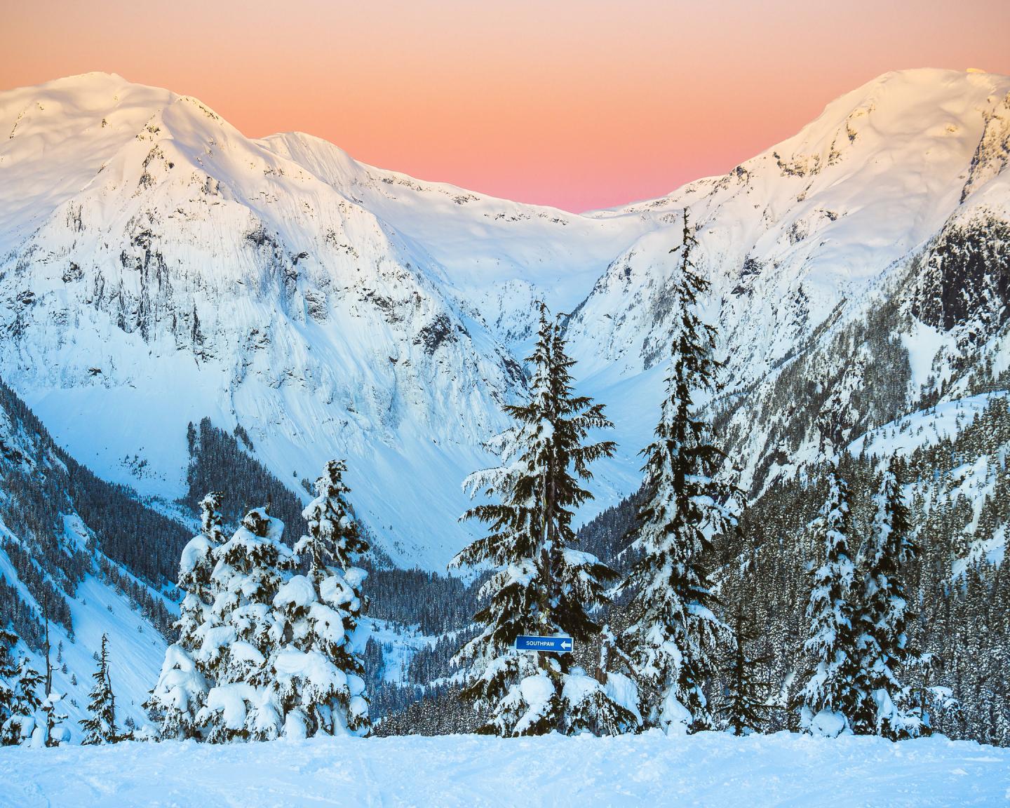 Shames Mountain in Canada - the sun is setting on a snowy mountain.