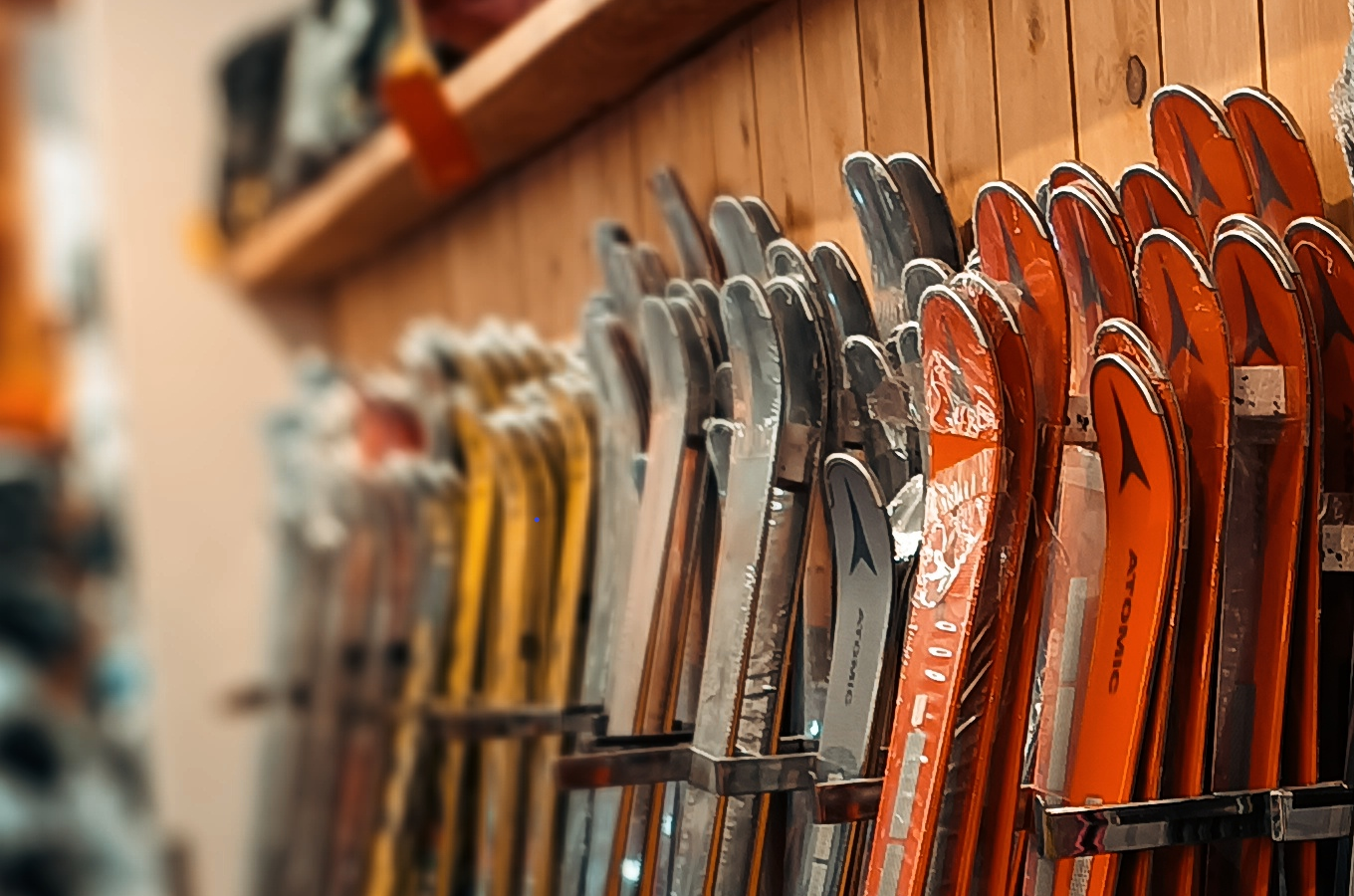 A skier glides down a snow covered slope at the Mont Sutton winter sports centre in Sutton Quebec Canada with a charming chalet and ski resort in the backdrop.