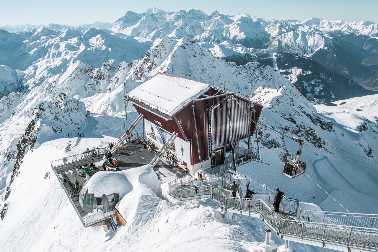 Auronzo di Cadore – Monte Agudo in Italy: a red building on top of a snowy mountain.