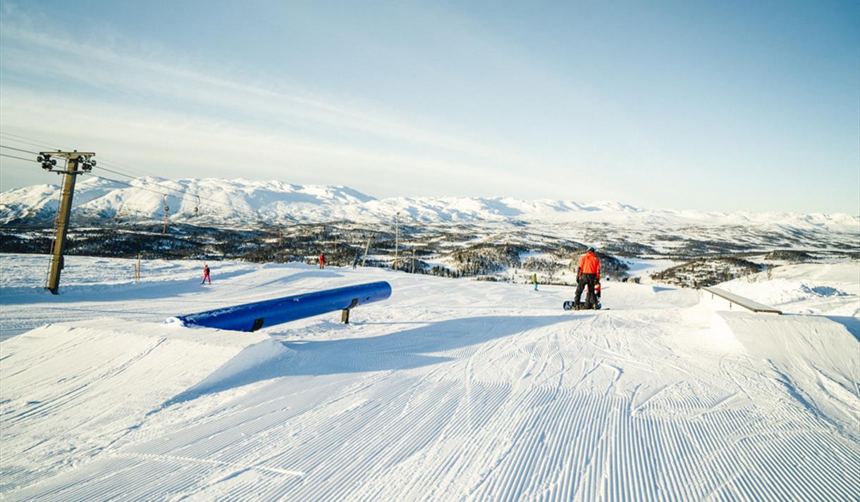 Rauland Skisenter in Norway - a person on a snowboard in the snow.
