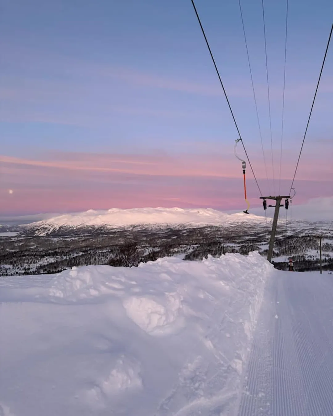 Rauland Skisenter in Norway - a ski lift going up a snowy mountain.