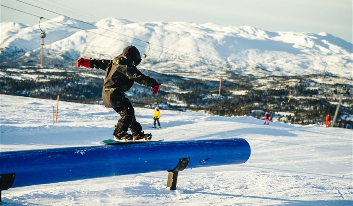Rauland Skisenter in Norway - a snowboarder doing a trick on a rail.