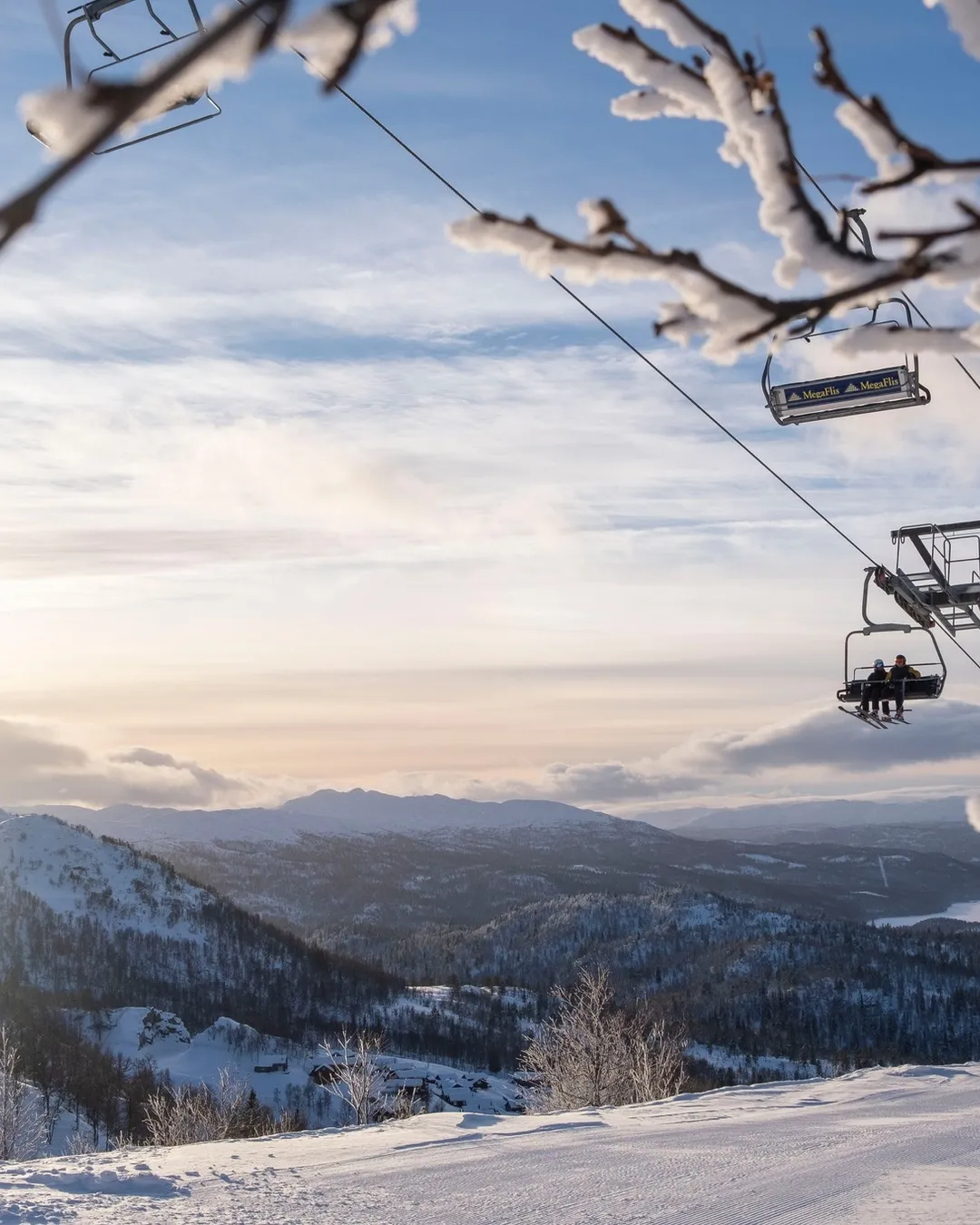 Rauland Skisenter in Norway - a ski lift going up a snowy mountain.