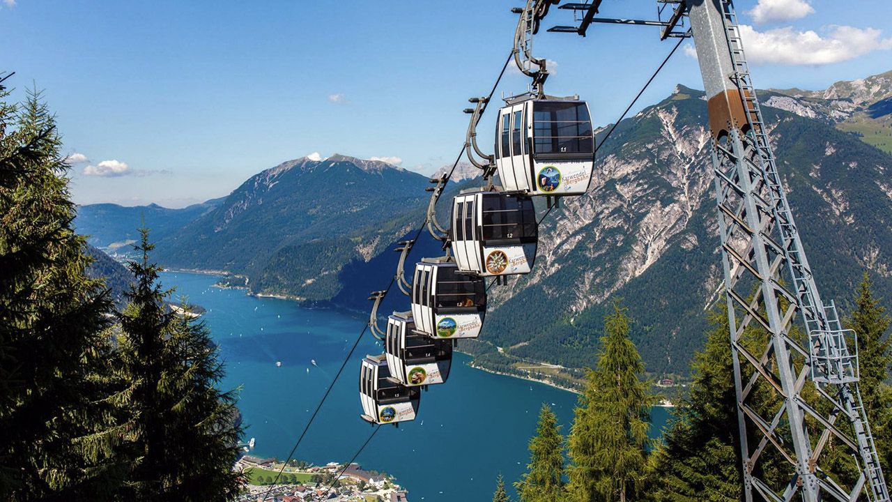 Karwendel Bergbahn – Pertisau in Austria - a cable car going up the side of a mountain.
