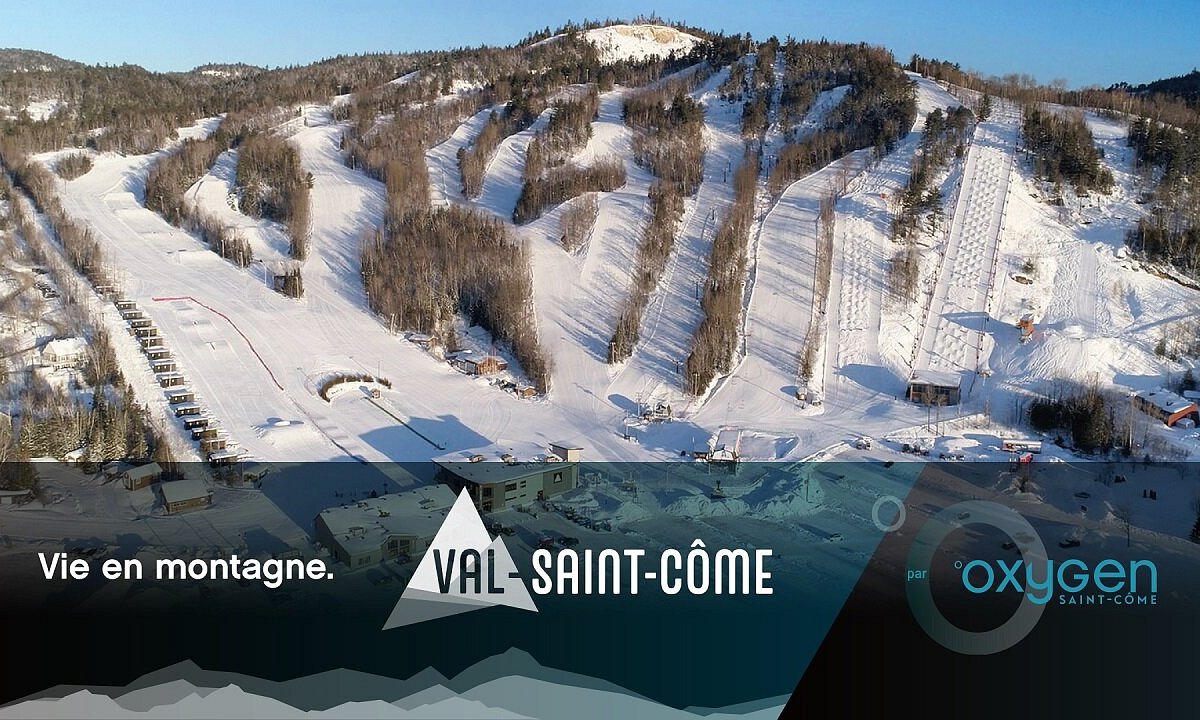 Val Saint-Come in Canada: an aerial view of a ski resort with a mountain in the background.