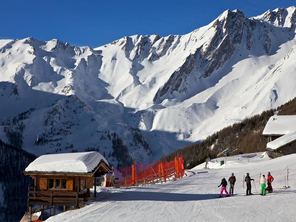 Crévacol in Italy - a group of people skiing down a mountain.