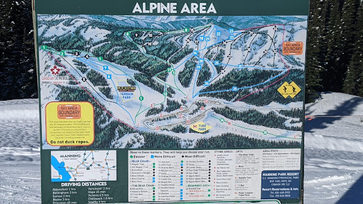 Ski resort in Manning Park, British Columbia, featuring ski lifts and a chalet amidst a bustling winter sports scene.