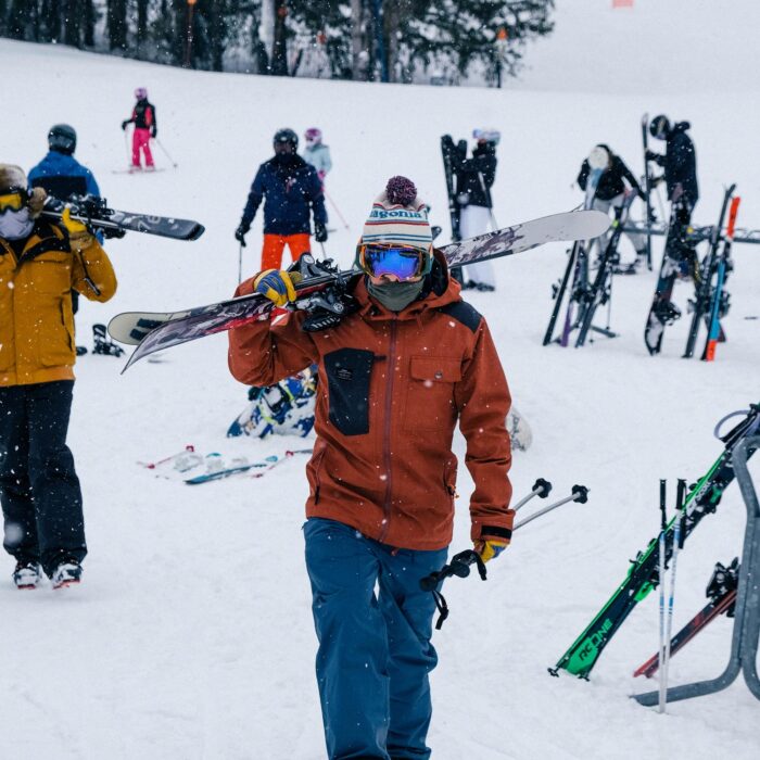 A snowboarder navigating the slopes at Holimont, in Ellicottville, New York. The mountain landscape is blanketed in snow, capturing the thrill and beauty of snowboarding.