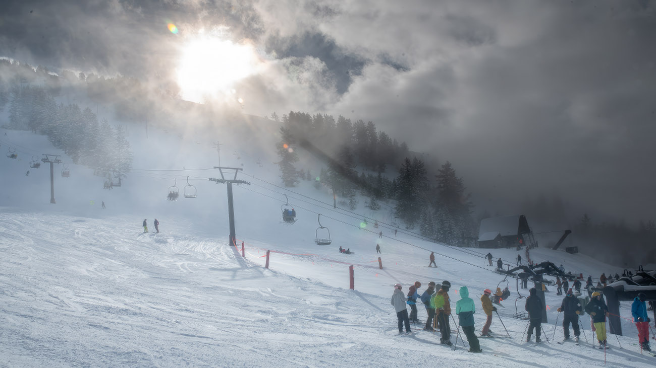 Pebble Creek in USA - a group of people skiing down a snowy slope.