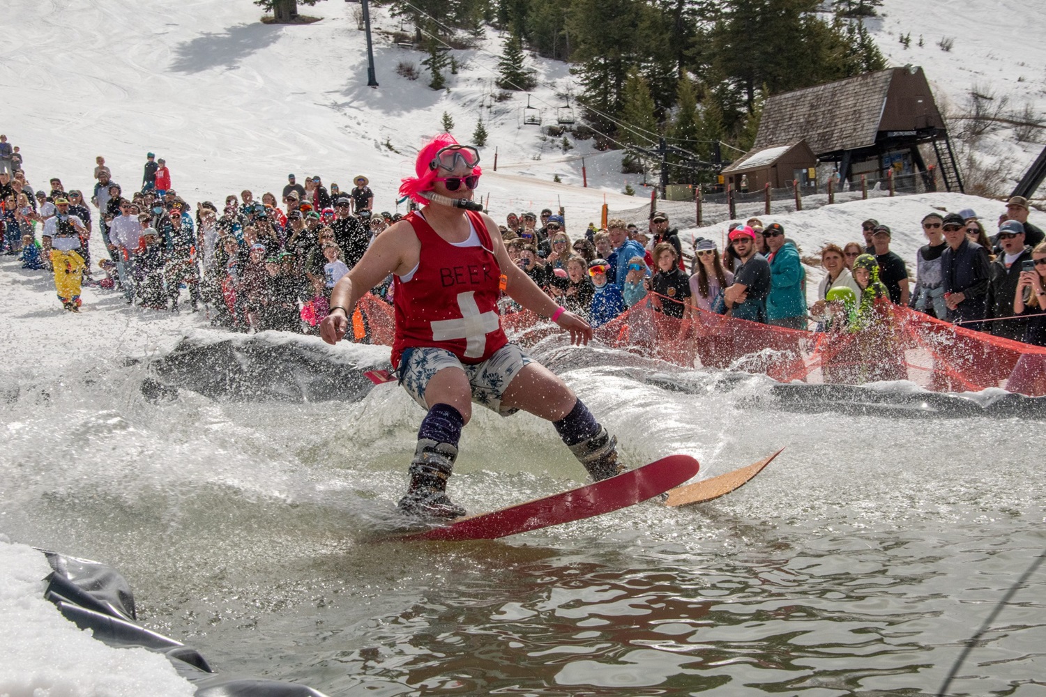 Pebble Creek in USA - a man riding a snowboard in a body of water.