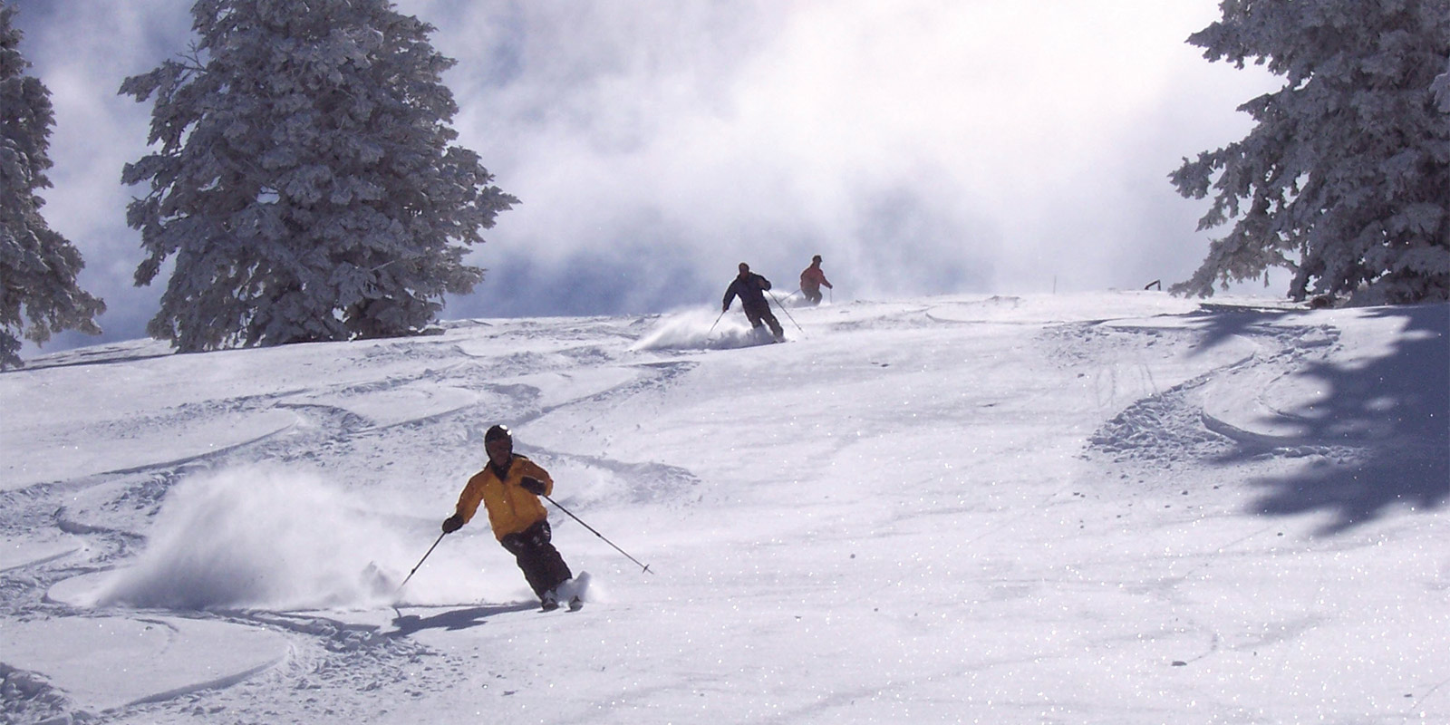 Pebble Creek in USA - a group of people skiing down a snowy slope.
