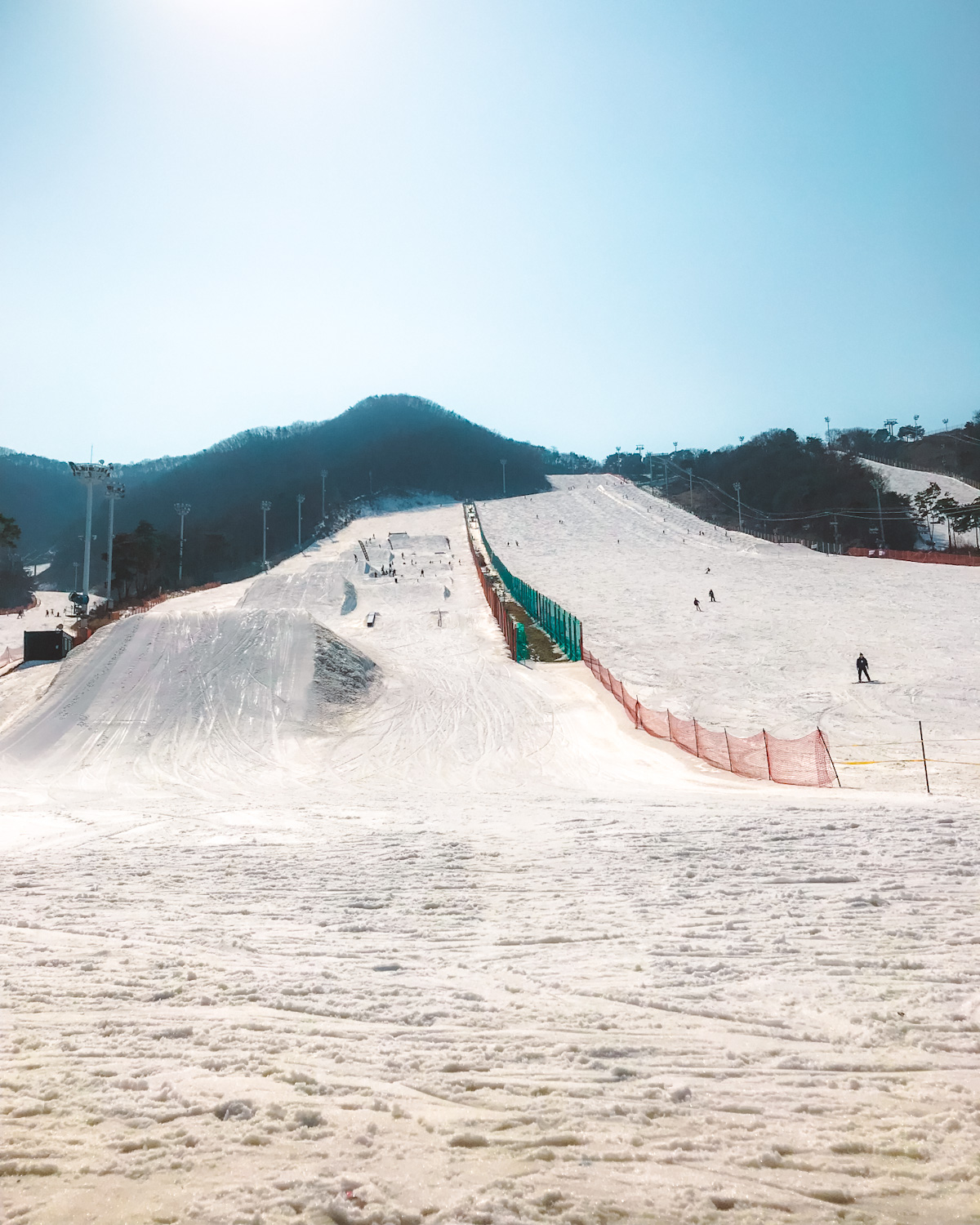 Jisan Forest Resort in South Korea - a man riding a snowboard down a snow covered slope.