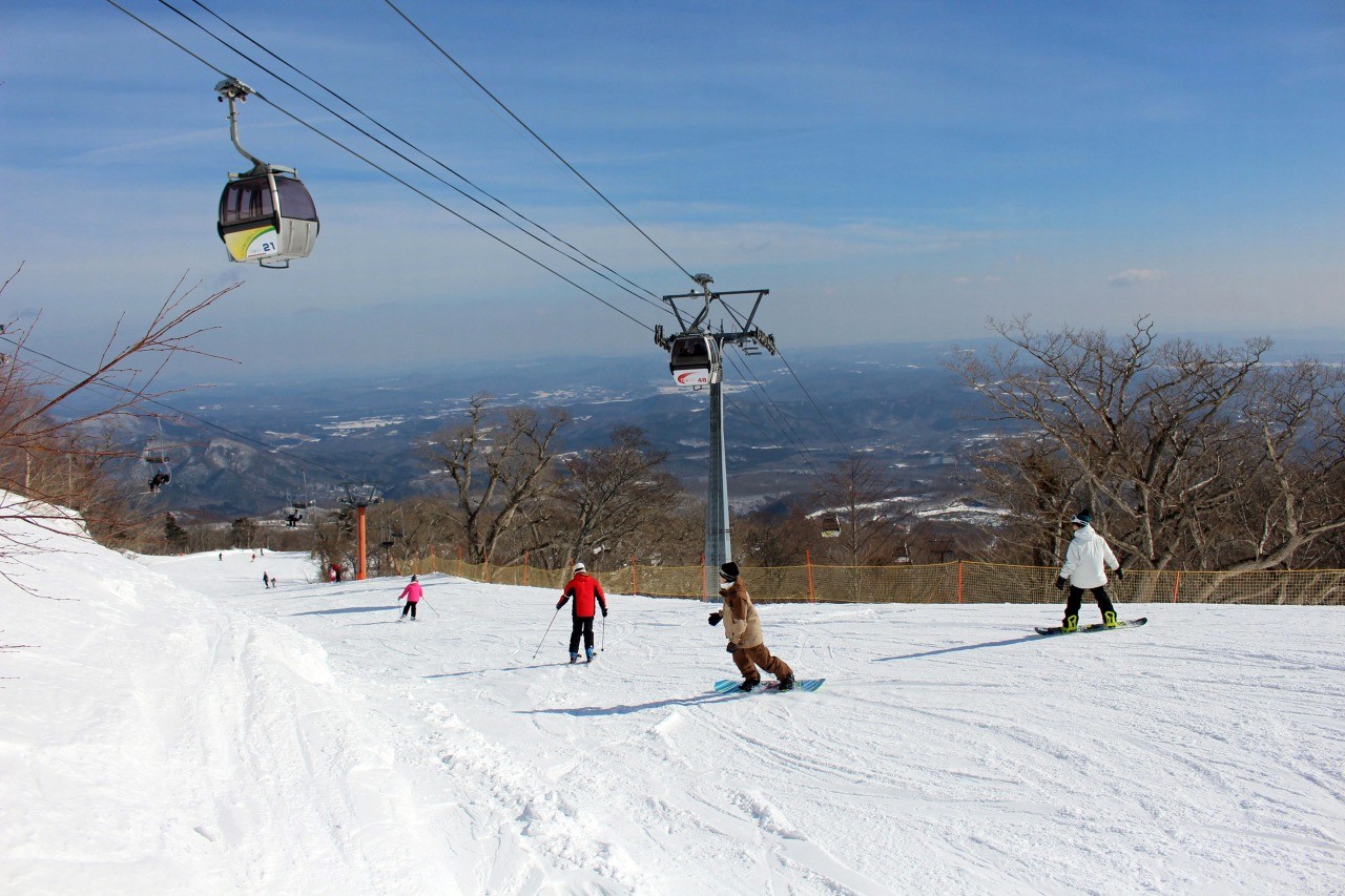 Miyagi Zao Eboshi Resort in Japan - a group of people riding down a snow covered slope.