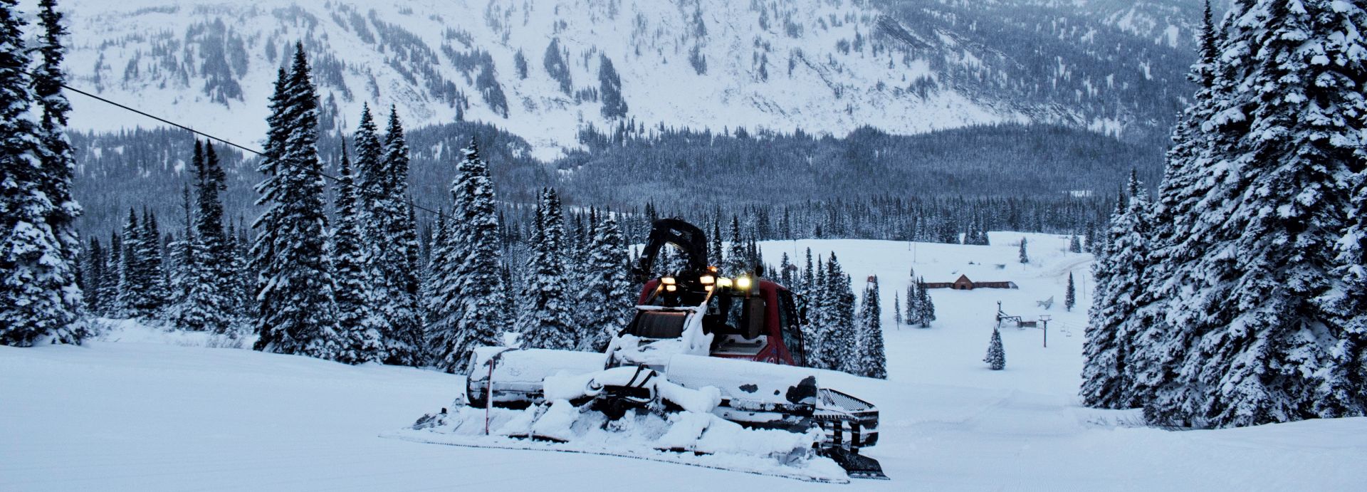 Powder King in Canada - a person on a snowmobile in the snow.