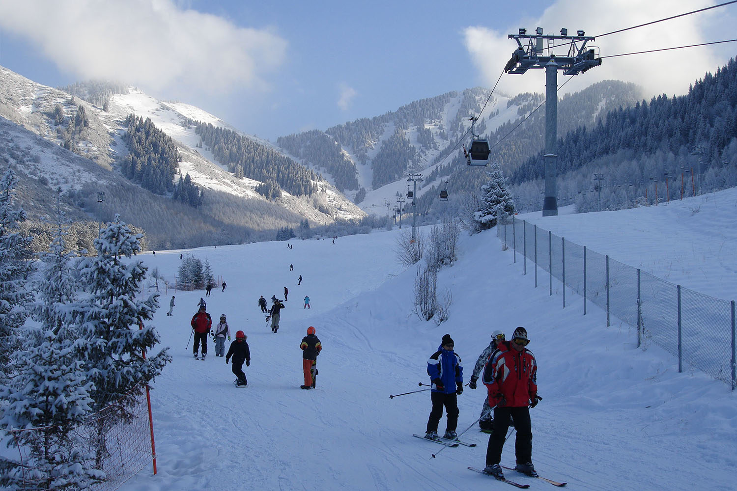 Ak Bulak in Kazakhstan - a group of people skiing down a snowy slope.