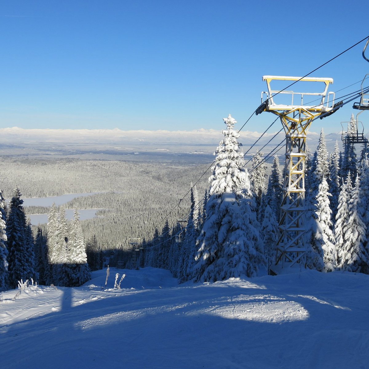 Purden Ski Village in Canada - a ski lift going up a snowy mountain.