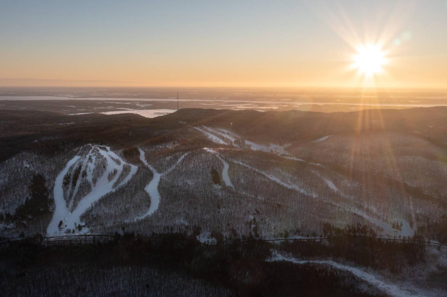Camp Fortune in Canada - the sun is setting over the mountains in the distance.